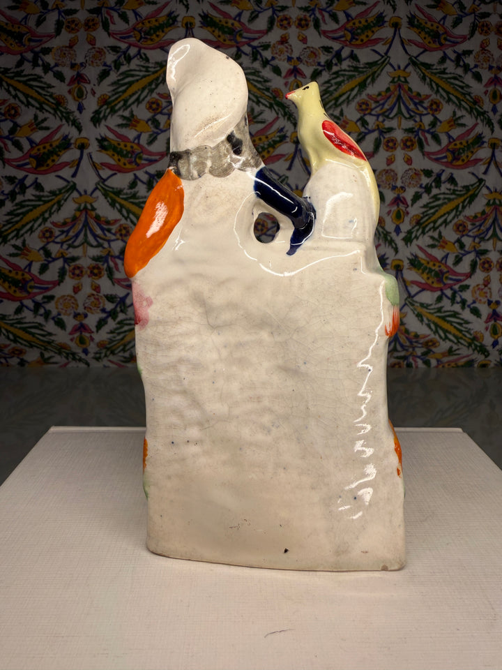 Staffordshire Pottery Figure of a Seated Woman with Bird and Dog
