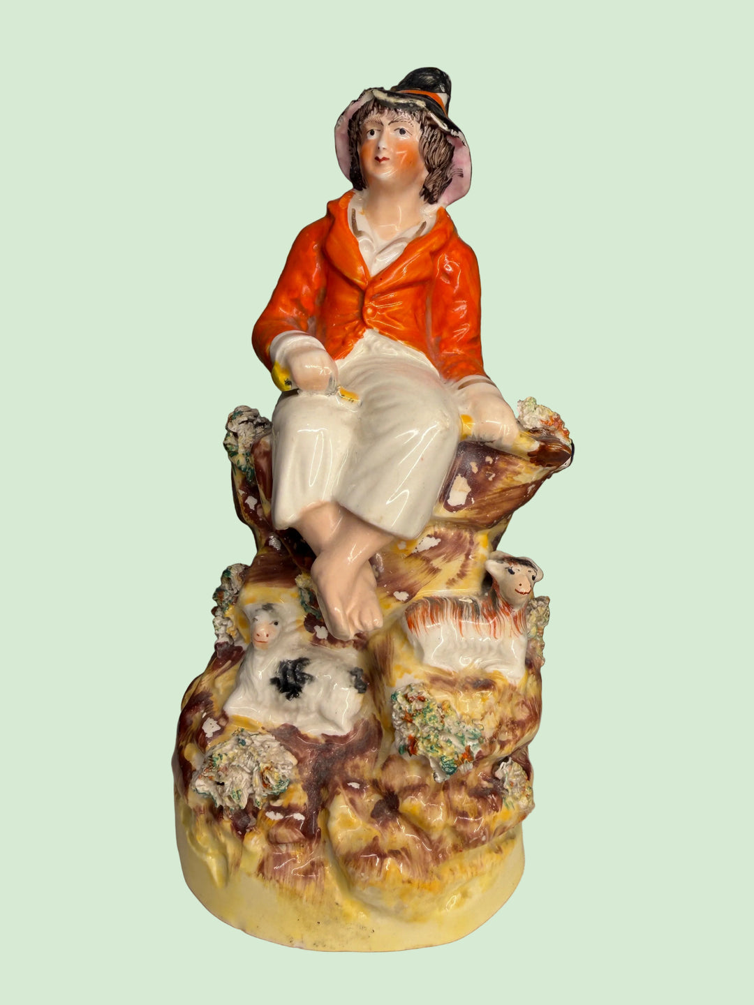 Staffordshire Pottery Figure of a Seated Youth with Sheep