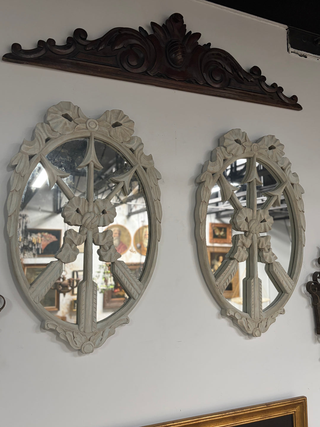 Pair of Oval White Carved Resin Wall Mirrors with Bow & Arrow Motif