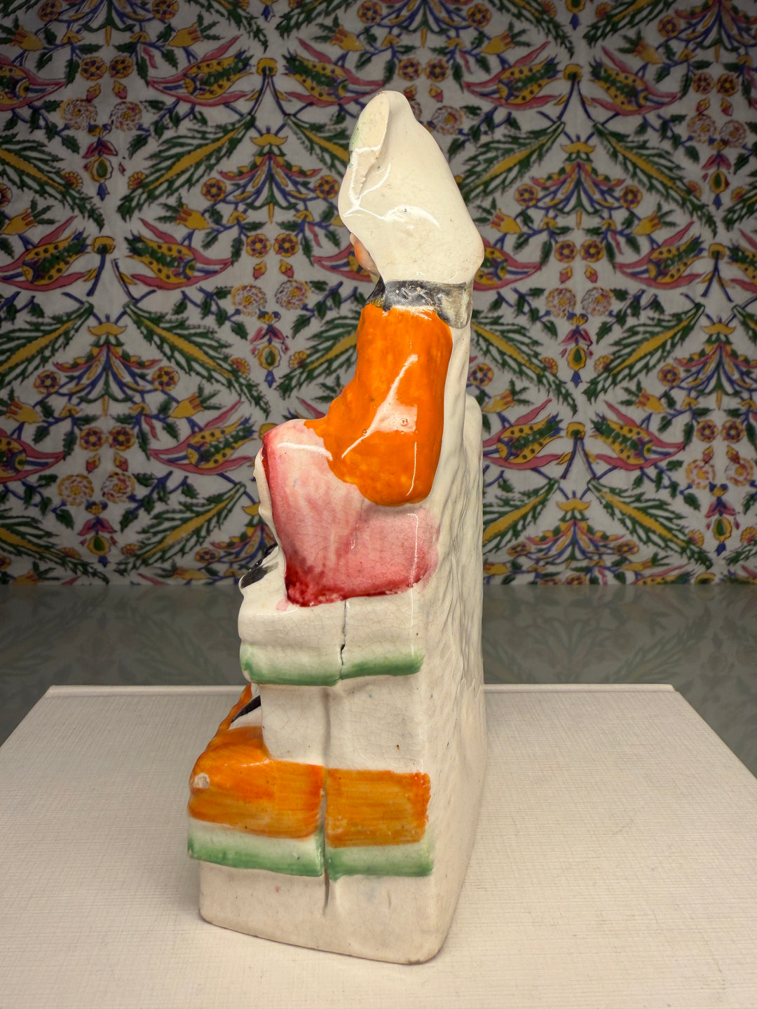 Staffordshire Pottery Figure of a Seated Woman with Bird and Dog